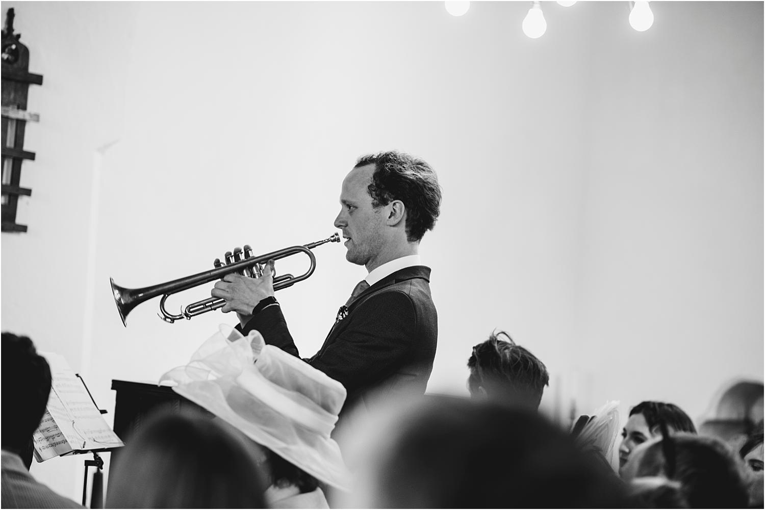 trumpet player at a festival themed wedding
