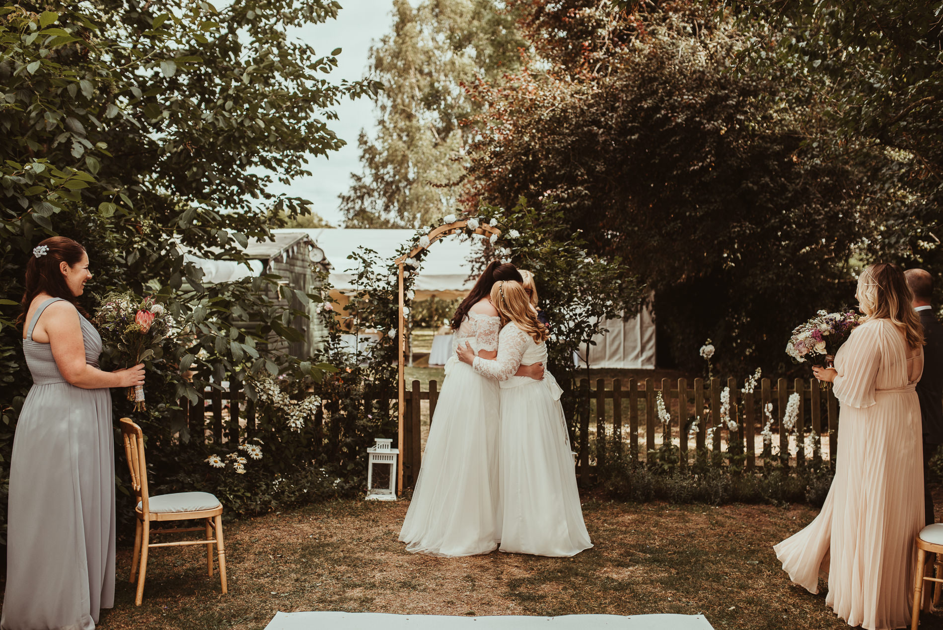 brides hugging same sex wedding cambridge back garden