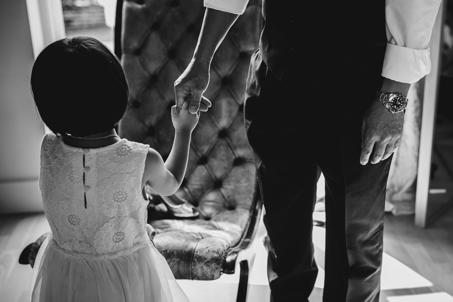 flower girl holiding dad's hand at White Dove Barn