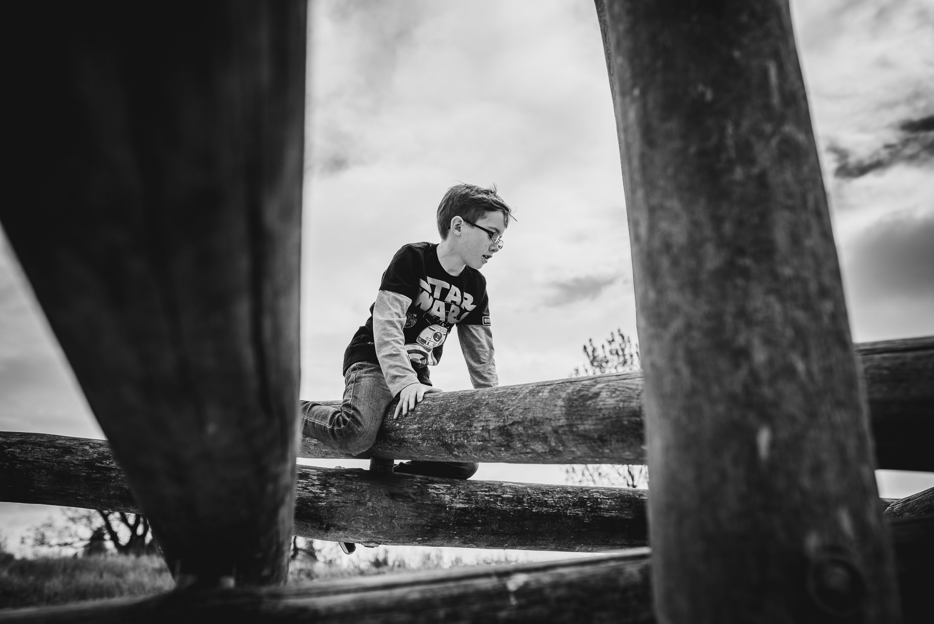 Boy climbing family photographer